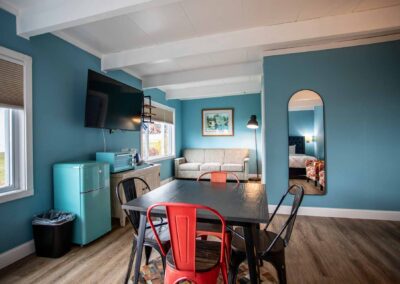 A view of the sitting area, TV, dining area and appliances in Room 110