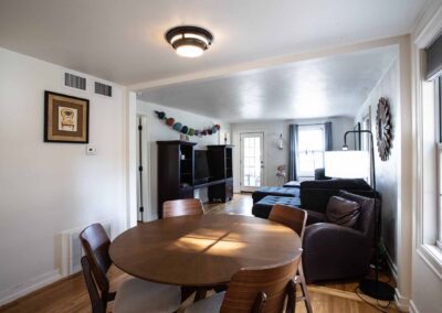 View from dining area into living room in The Cottage at Beachfront Inn